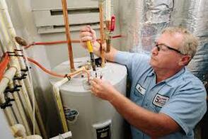 Electrican installing hot water heater